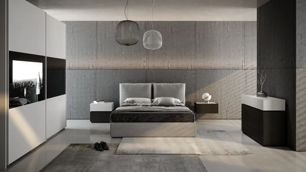 Camera da letto Aversa di BEHOME con letto grigio, arredi moderni bianchi e neri e grande armadio con TV integrata.