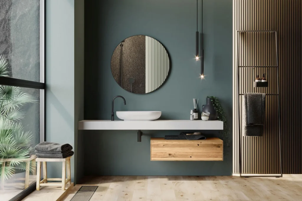 Mobile bagno sospeso Marek di BEHOME con piano bianco, cassetto in legno e specchio rotondo.